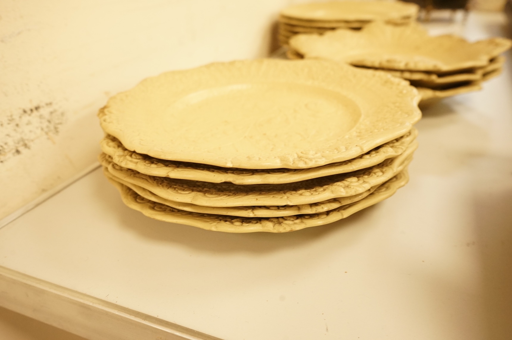 A Victorian drabware part dessert set, comprising eleven plates and three two handled dishes, dishes 25cm wide